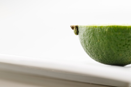 A portion of a fresh organic lime shot in a creative abstract manner against a white backgroundの写真素材