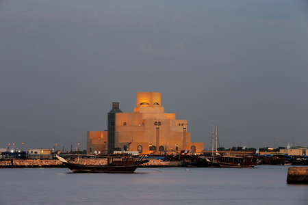 Doha, Qatar   Dhow are anchored in the port beside the Museum of Islamic Art at dusk