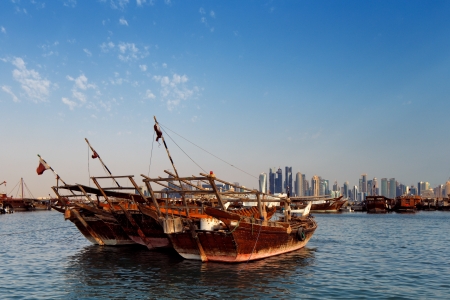 Doha, Qatar  Traditional sail boats called Dhows add life and energy to the dynamic skyline of the West Bay areaのeditorial素材