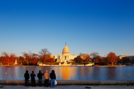 The United States Capitol building behind the Capitol Reflecting Pool in Washington DC, USA  It is...