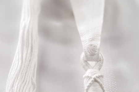 An abstract detail of a Tarboosh which is an Arabic style  tassel like  tie that is usually worn with a thawb or kandura in Arabia の写真素材