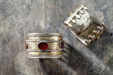 Afghanistan  Traditional Ornate Afghani jewelry in the form of bracelets, shot on an old wooden...