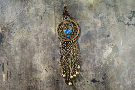 Traditional silver jewelry from the southern Arabian Peninsula shot on a textured wooden tableの写真素材