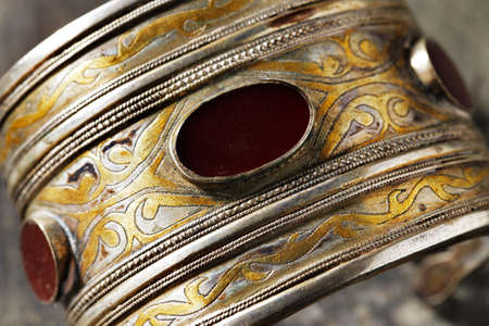 Afghanistan  Traditional Ornate Afghani jewelry in the form of bracelets, shot on an old wooden surfaceの写真素材