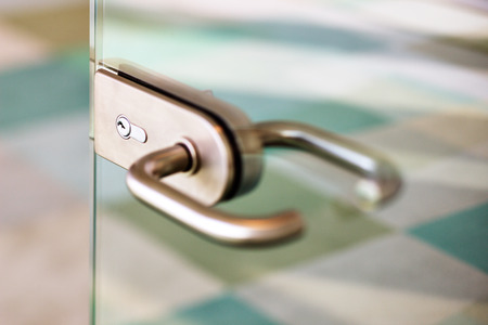 An abstract detail of a contemporary door handle for a glass doorの写真素材