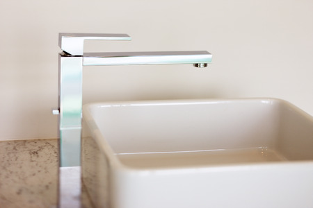 An abstract detail of a contemporary wash-hand basin and faucetの写真素材
