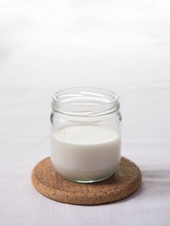 Close up of a glass of milk on a white backgroundの写真素材