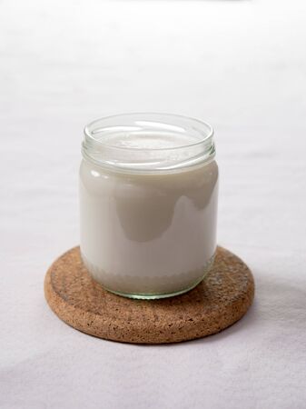Close up of a full glass of milk on light backgroundの写真素材