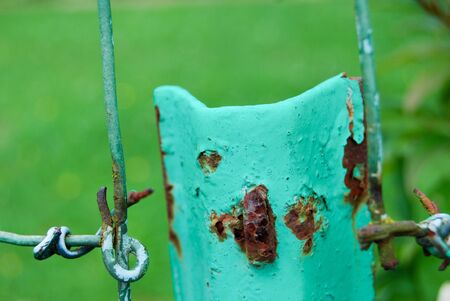 Rusty and twisted wire on a fence in a countryside fieldの写真素材