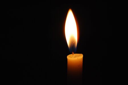 Candle that are lit in the dark. Flame in darknessの写真素材