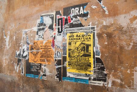 street posters and graffiti on the wall in Pisa, Tuscanyのeditorial素材