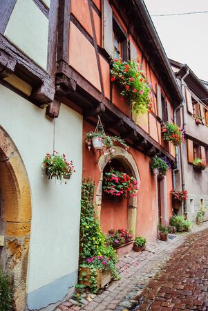 Pretty little flowery street with its traditional houses, in Alsaceのeditorial素材