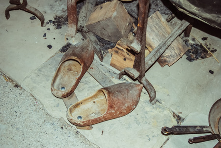 Ungersheim, France - July 21 2012: Old and vintage wooden clogs in an old traditional Alsatian house...