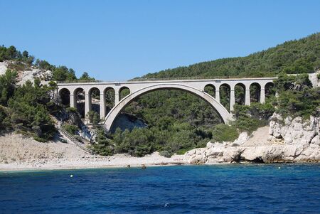 Beautiful view of the sea with a bridge and mountain rocks with trees in Provence, Marseilleの写真素材