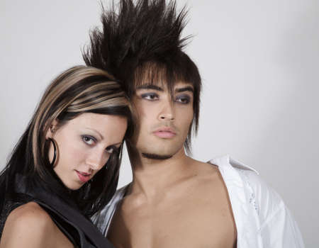 Young urban couple against a light gray backgroundの写真素材