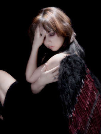 Beautiful dark angel at rest and thoughtfulの写真素材