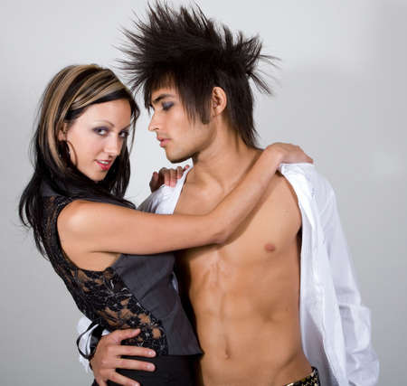 Young male and female urban couple in coy poseの写真素材