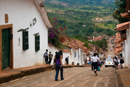 School children running the streets of the colonial village of Barichara, Santander, Colombiaのeditorial素材