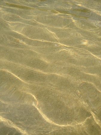 Clear shallow waters on a sandy beach の素材