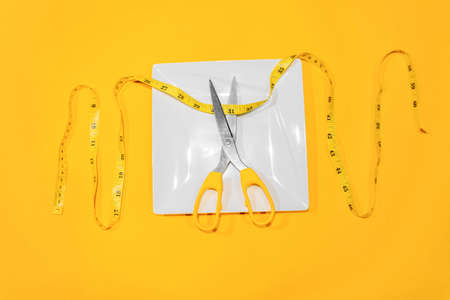 Showing excess weight gain around the waist with a tailor's tape measure.の写真素材