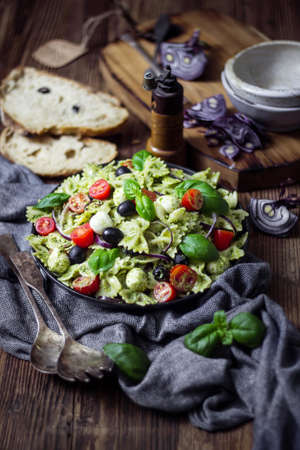 Pasta salad with arugula pesto and mozzarella. Italian cuisine.の写真素材
