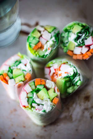 Spring Rolls. Vietnamese cuisine full of flavor. An Asian snack consisting of rice paper filled 
with minced vegetables and usually meat, rolled into a cylinder and fried.の写真素材