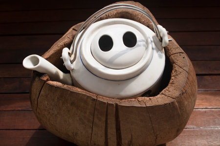 A teapot for brewing tea in a coconut shell. Coconut shell gives you a hot or cold tea depending on...