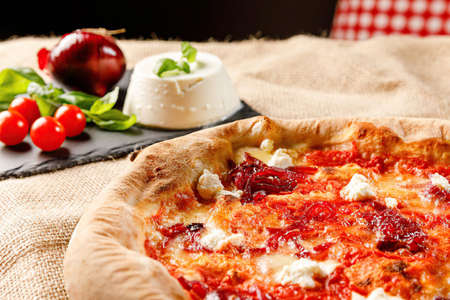 Pizza with Feta cheese. Composition with vegetables and cheese. Delicious meal.の写真素材
