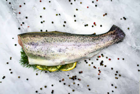 Fresh cod carcass decorated with lemon slices and dill. Cuisine for the seafood gourmet. Top view.