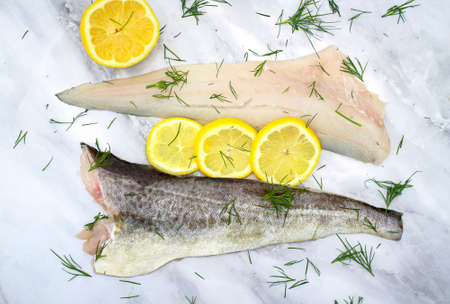 Fresh, raw trout carcass decorated with lemon slices and dill. Cuisine for the seafood gourmet. Top...