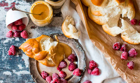 Sweet yeast bread braided with peanut butter, decorated with raspberries. Delicious dessert, breakfast or a sweet gourmet lunch. American-Austrian cuisine.の写真素材