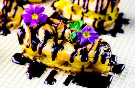Eclairs stuffed with rich, creamy Vanilla Pastry Cream. Decorated with flowers and covered with...