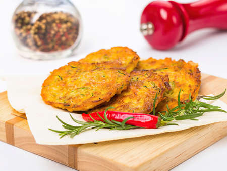 Fried potato pancakes (German Kartoffelpuffer). German cuisine. Isolated on a white background. Side...