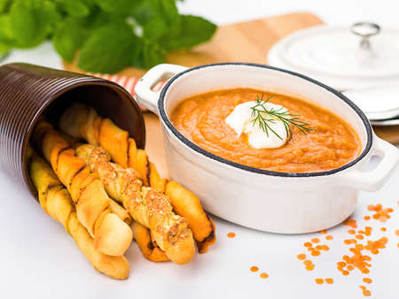 Pumpkin cream seasoned with cream. Served with Italian Grissini bread sticks. French cuisine.
Isolated on a white background. Side view.の写真素材