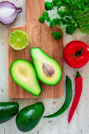 Basic ingredients for the preparation of the Mexican Guacamole dip. Isolated on a white background.
