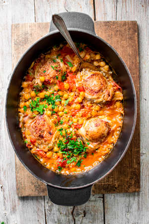 Paella (Paella valenciana) from the oven with pieces of baked chicken. Spanish cuisine. Gourmet meal. Top view.の写真素材