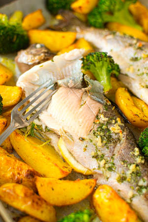 Baked rainbow trout served with baked potatoes and broccoli. Lean fish meat recommended in a diet...