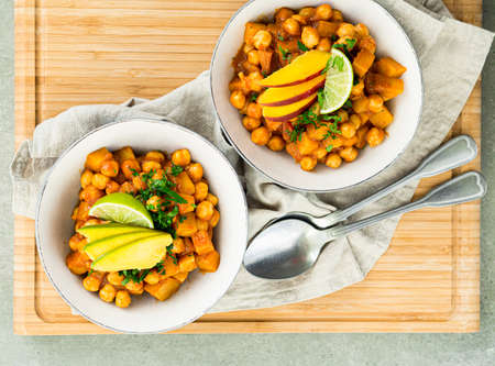 Chana masala also known as channay, chole masala, chhole masala, chole or chholay, is a dish originating from the Indian subcontinent. This version is served with baked potatoes and fresh fruits.の写真素材