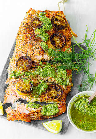 Baked Salmon with Argentinean Chimichurri sauce with a hint of avocado. French cuisine with an oriental twist. Isolated on a white background.の写真素材