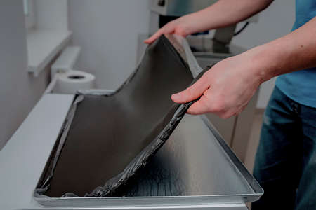 Preparation of the Fango compress for therapy. Paraffin compresses are used to perform fango massages.の写真素材