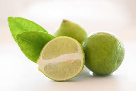 Lime and its cross section decorated with a leaf. Isolated on a white background. Food. Healthy...