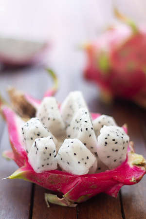 Diced white dragon fruit (pitaya) lying on the table.	Ready-to-eat. Close-up. Gourmet dessert. Culinary concept.の写真素材
