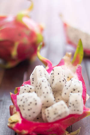 Diced white dragon fruit (pitaya) lying on the table.	Ready-to-eat. Close-up. Gourmet dessert. Culinary concept.の写真素材