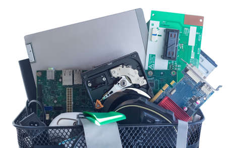 Discarded, used and old computer hardware (electronics scraps) in the electronic waste bin. Isolated...