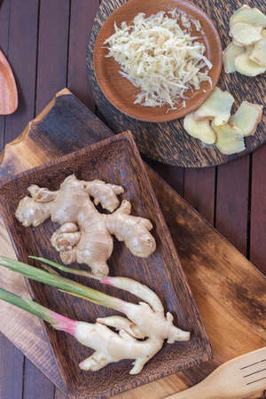A mild spicy Galangal and spicy freshly ginger roots sliced and cut into shavings - lying on a tray...