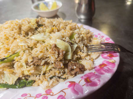 Fried rice with fried egg, shredded beef, and vegetables. Rapprochement. Nutritious meal containing a lot of carbohydrates.  Close-up. Night scenery. Asian cuisine.の写真素材