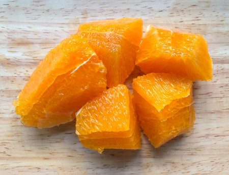 Orange pulp lice on wooden cutting board, closeup, top view, can use be background or wallpaperの写真素材