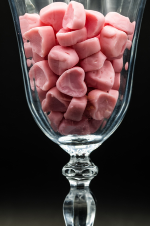 heart-shaped candies in a champange glassの写真素材