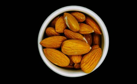 Salted almonds in a whire porcelain cupの写真素材