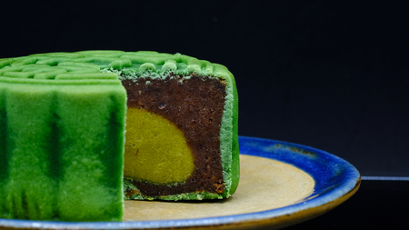 moon-cake, a traditional chinese dessert made of pastry with sweet cranberry and bean paste fillingsの写真素材
